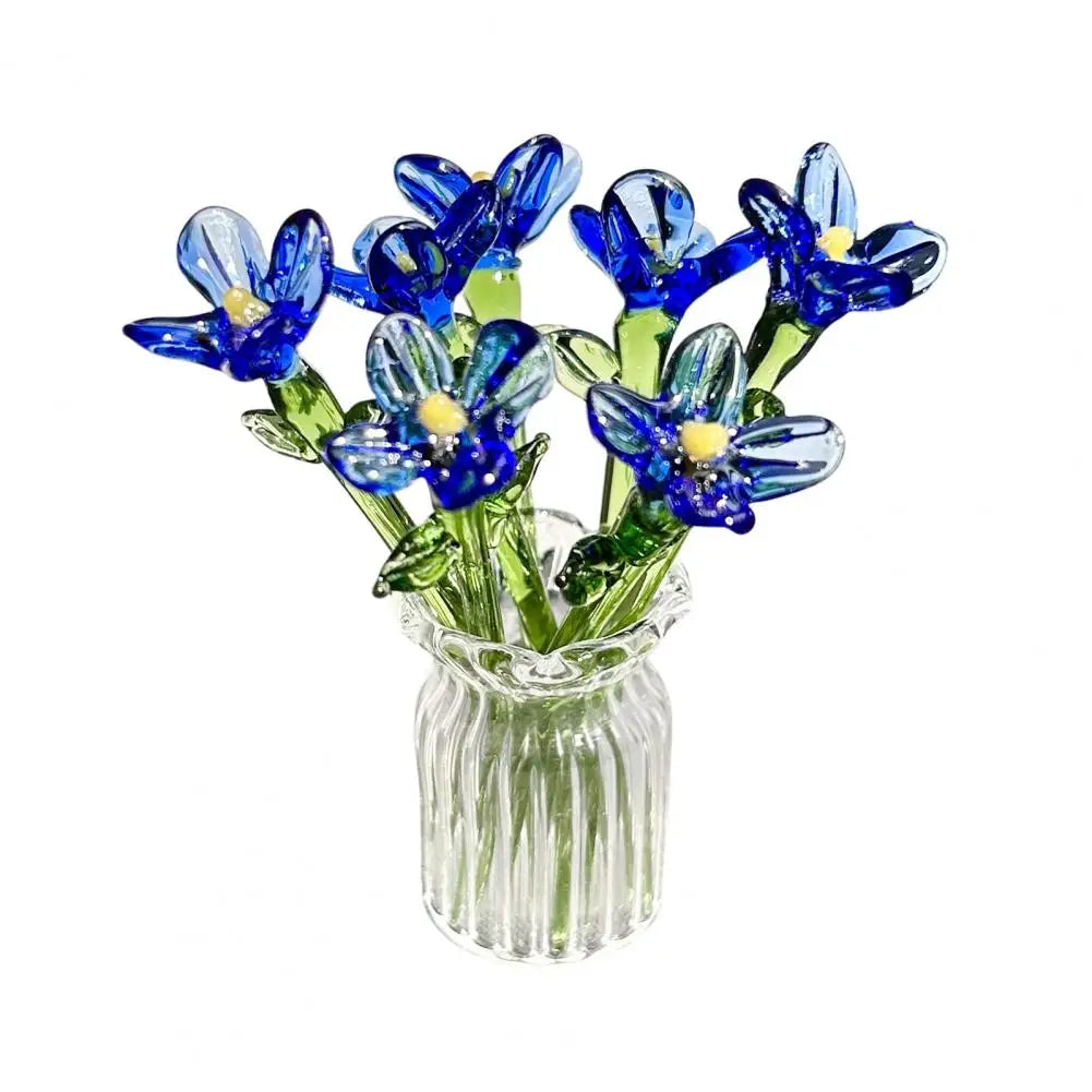 Hand-blown glass flower bouquet of blue and yellow flowers in a clear glass vase