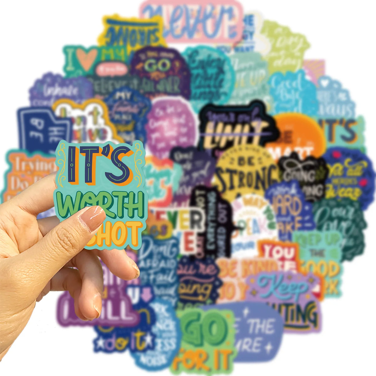 A hand holds a colorful collection of inspirational quote stickers on a white background.