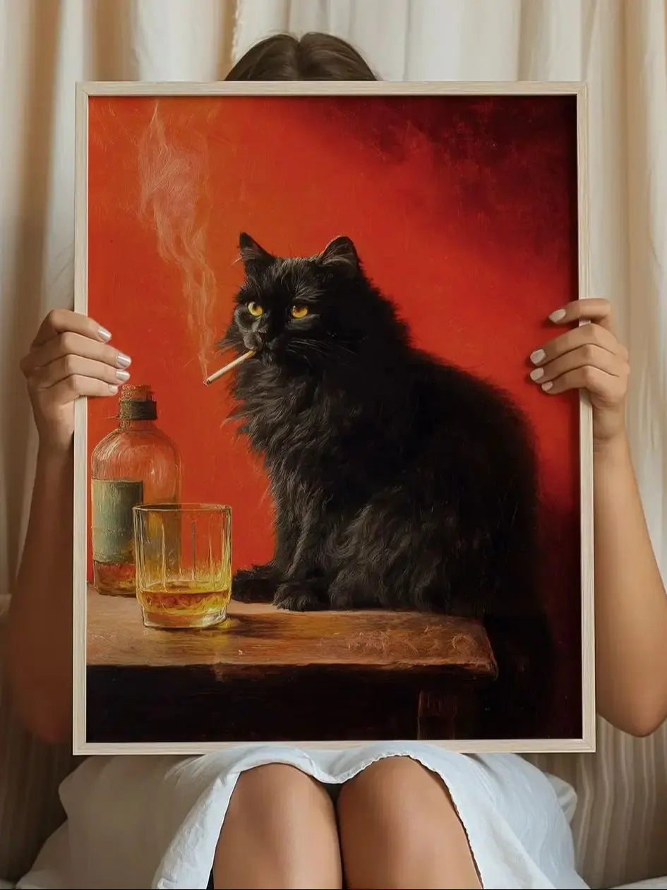 A black cat sits on a wooden surface next to a glass of amber liquid, set against a red background.