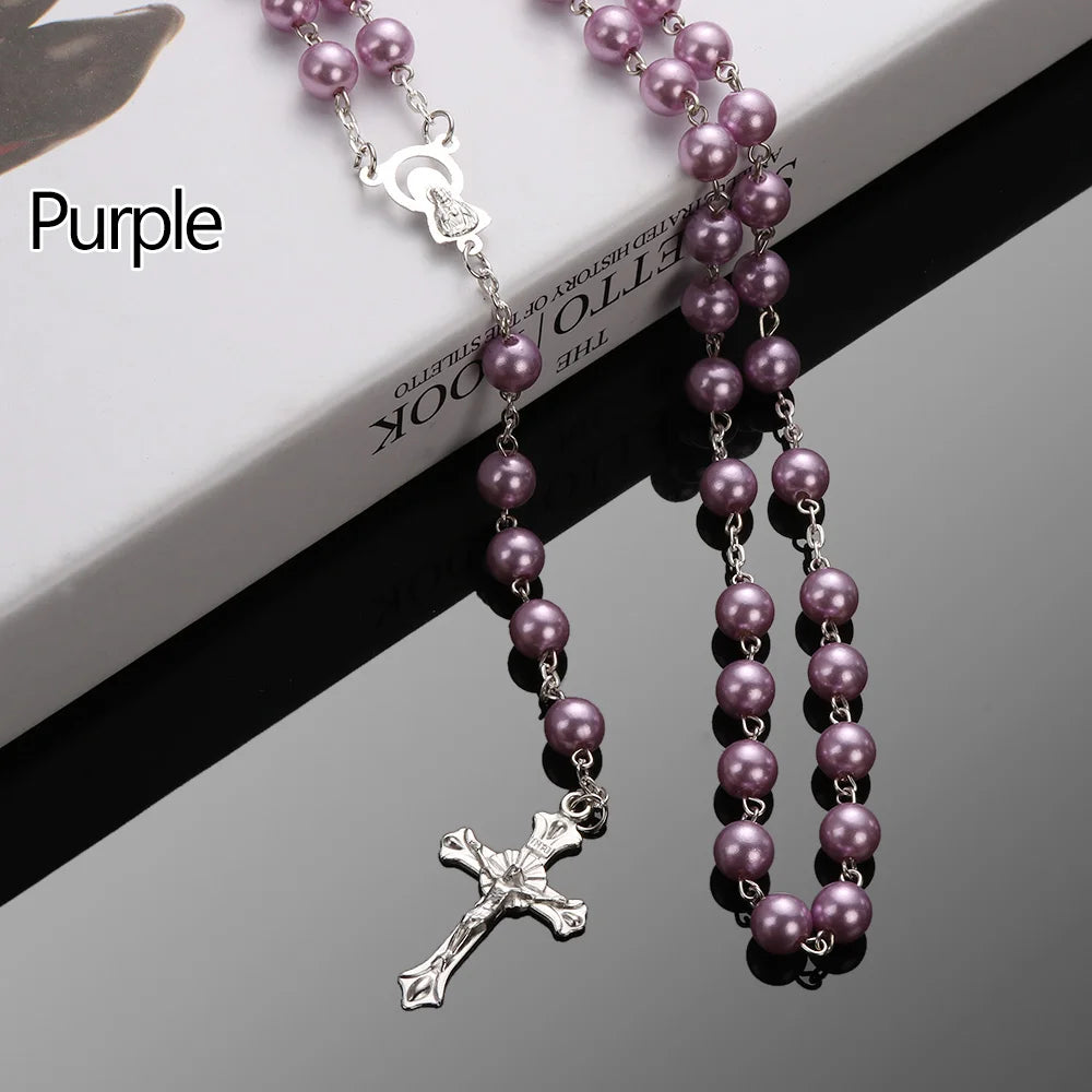 A purple rosary necklace featuring a vintage cross and Virgin Mary pendant on a silver chain.