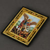 A framed icon depicting the Catholic Holy Family with an archangel, set in a gold-edged black frame.