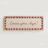 A rectangular canvas print with a light beige background and a pink border featuring the text Love you bye!