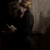 A dark, moody painting depicting two figures in silhouette studying or interacting near a wooden surface.