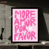 A framed print featuring the pink text MORE AMOR POR FAVOR on a light pink background.