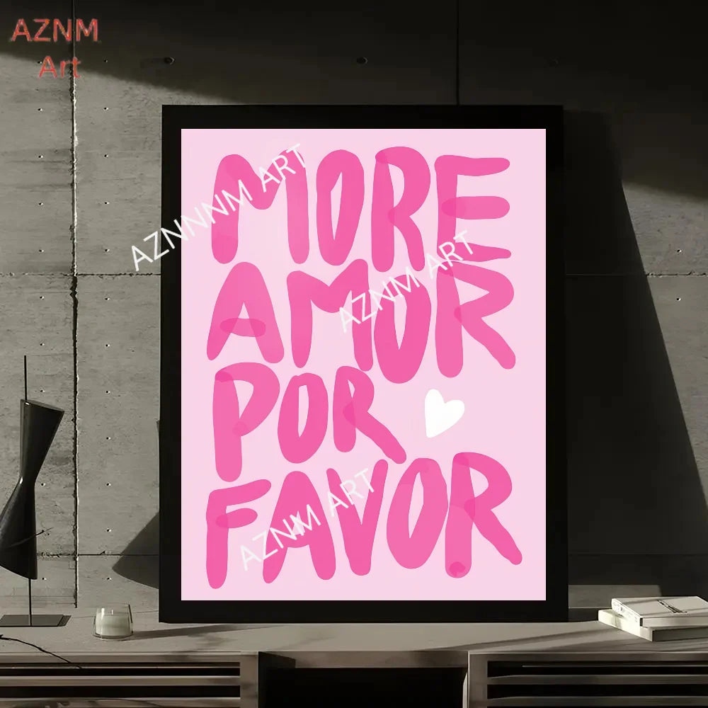 A framed print featuring the pink text MORE AMOR POR FAVOR on a light pink background.