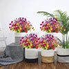 A collection of mixed color artificial flowers in various shades of pink, purple, yellow, and green displayed in white and na