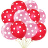 Un grupo de globos de látex rojos y rosas de lunares para decoración de fiesta.