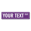 A purple rectangular sign with white text that reads YOUR TEXT TEXT