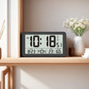 A digital wall clock displaying the time 10:18, date 8-23, temperature 23 degrees, and humidity 60 percent.