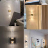 Modern bubble crystal LED wall sconces illuminating a bathroom and bedroom interior.