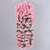 A vertical hanging garland made of pink artificial violet ivy flowers for home decor or weddings.