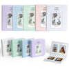 A set of five pastel-colored photo albums for instant cameras, featuring various sizes and designs.