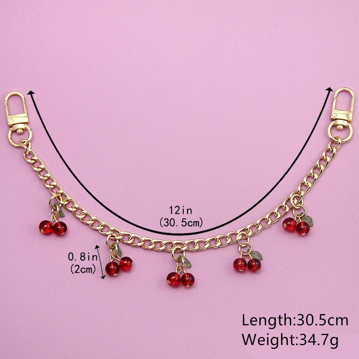 Gold chain necklace with red cherry charms and a clasp, measuring 30.5 cm long.