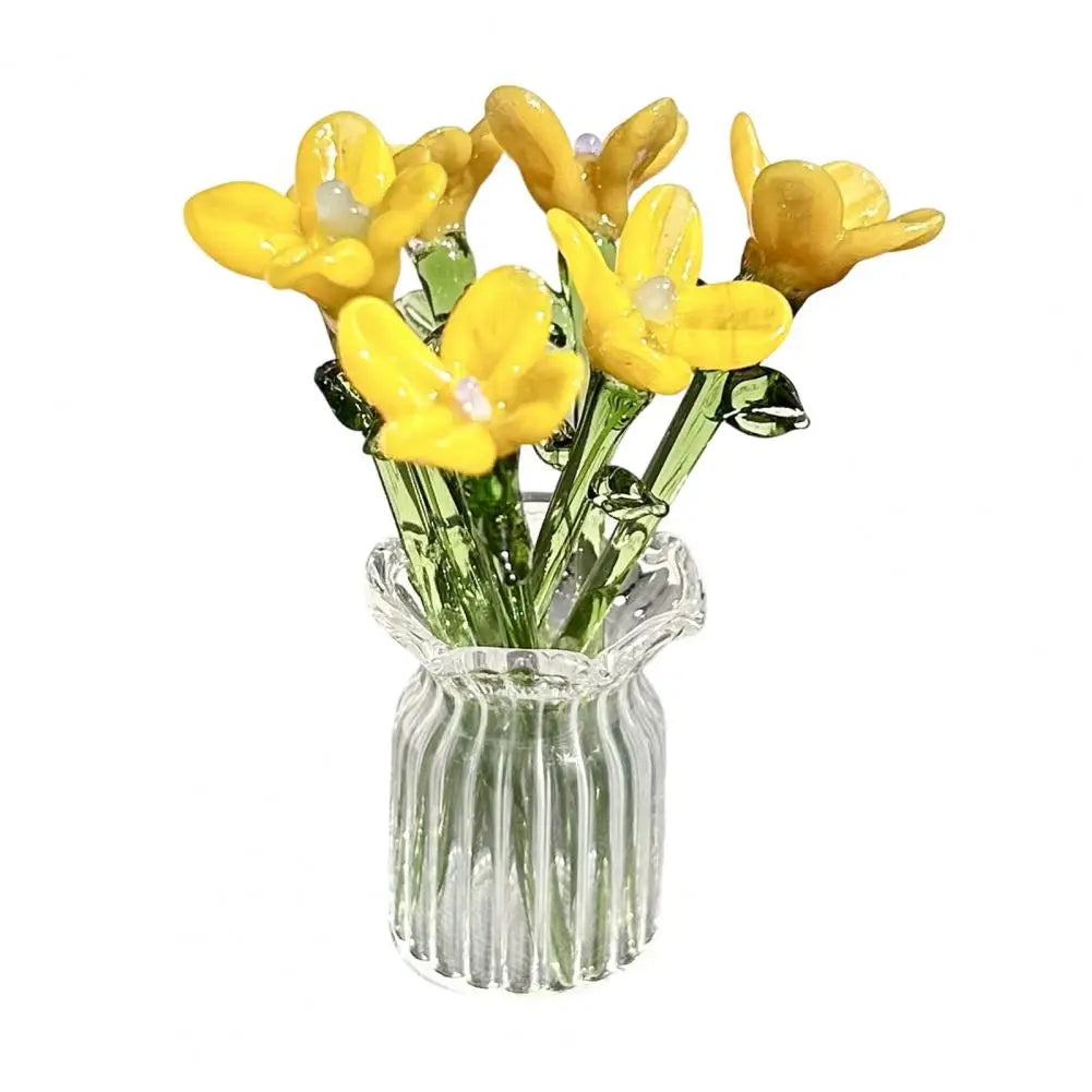 A bouquet of yellow glass flowers in a clear glass vase.