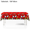 A red tablecloth decorated with superhero themes, including Spider-Man motifs and city skyline graphics.