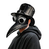 A person wearing a black plague doctor mask with large eye holes and a wide-brimmed hat, partially covered by a dark hooded g