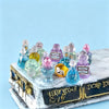 A collection of miniature resin magic potion bottles in various colors arranged on a white marble box.