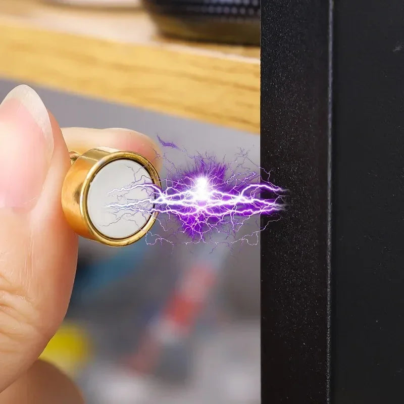 Eine Hand hält eine goldfarbene magnetische Nadel, die violette elektrische Funken ausstößt.