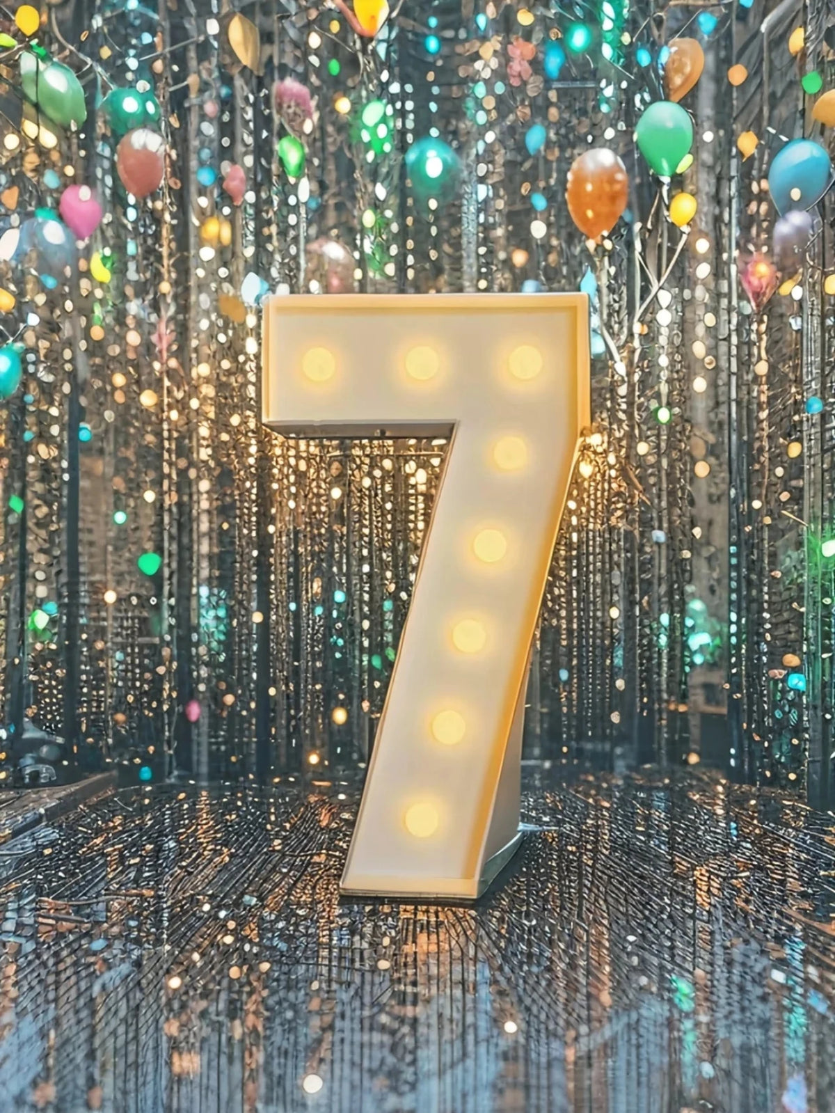A large illuminated number seven sign stands in front of a sparkling backdrop of hanging lights and balloons.
