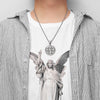 A stainless steel punk cross necklace with an intricate design is worn over a striped shirt.