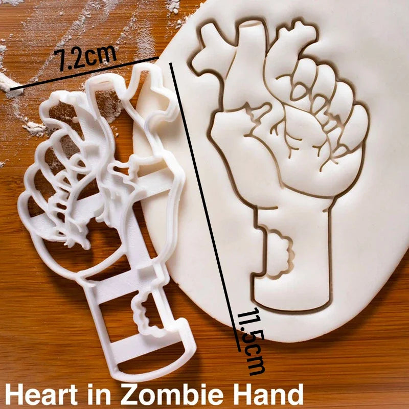 White fondant cookie cutter shaped like a zombie hand, shown next to a measuring scale.