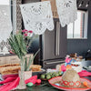White Mexican fiesta cutout banner for Dia de Muertos and party decor displayed with greenery and colorful accents