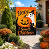 An orange Halloween flag featuring a ghost and text that reads Boo I Smell Children displayed outdoors.