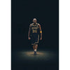 A portrait of a basketball player in a Lakers jersey with the number 24 standing against a dark background.