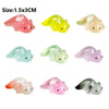 Five glow-in-the-dark fruit turtle resin charms in various colors and shades