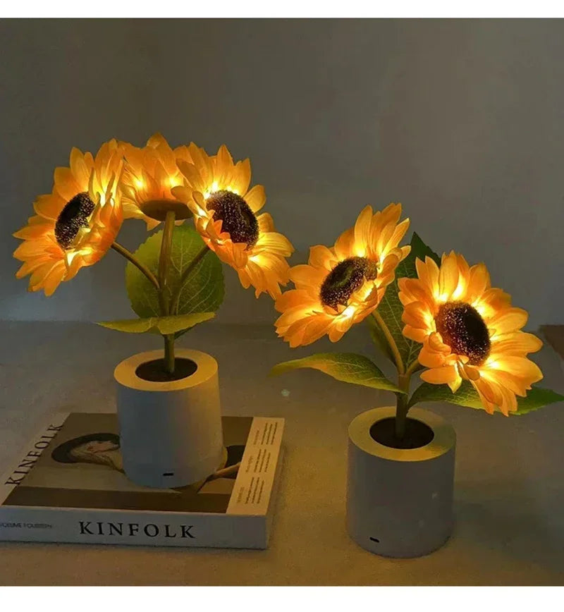A cluster of bright yellow orange sunflowers used as a decorative LED night light on a white base.