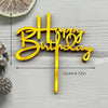 Gold acrylic birthday cake topper with the words Happy Birthday on a stick