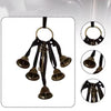 Un ensemble de poignées de porte de sorcière en bronze vintage avec clochettes et porte en tissu sombre.