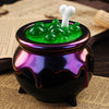 A purple glass jar filled with green silicone molds shaped like Halloween items, topped with a white silicone mold.