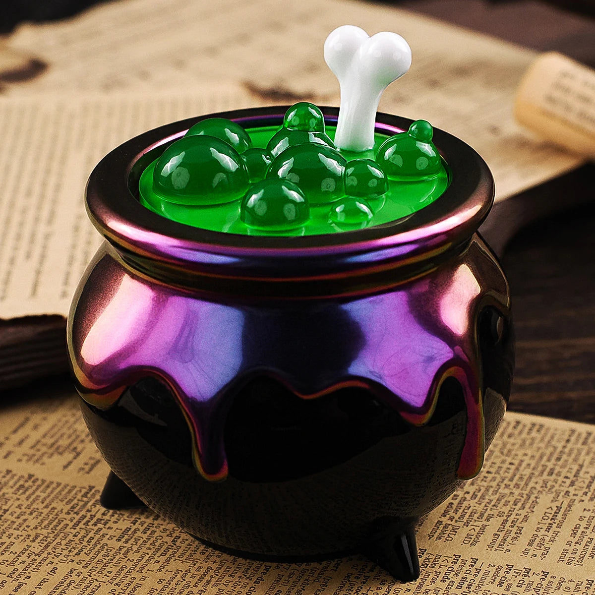 A purple glass jar filled with green silicone molds shaped like Halloween items, topped with a white silicone mold.