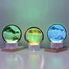 A 3D Quicksand LED table lamp with a color-changing light, featuring three glass spheres displaying different colored liquid 
