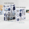 Two photo albums featuring blue and gray ceramic jars with floral designs, one 5 inch for 200 photos and one 6 inch for 100 p