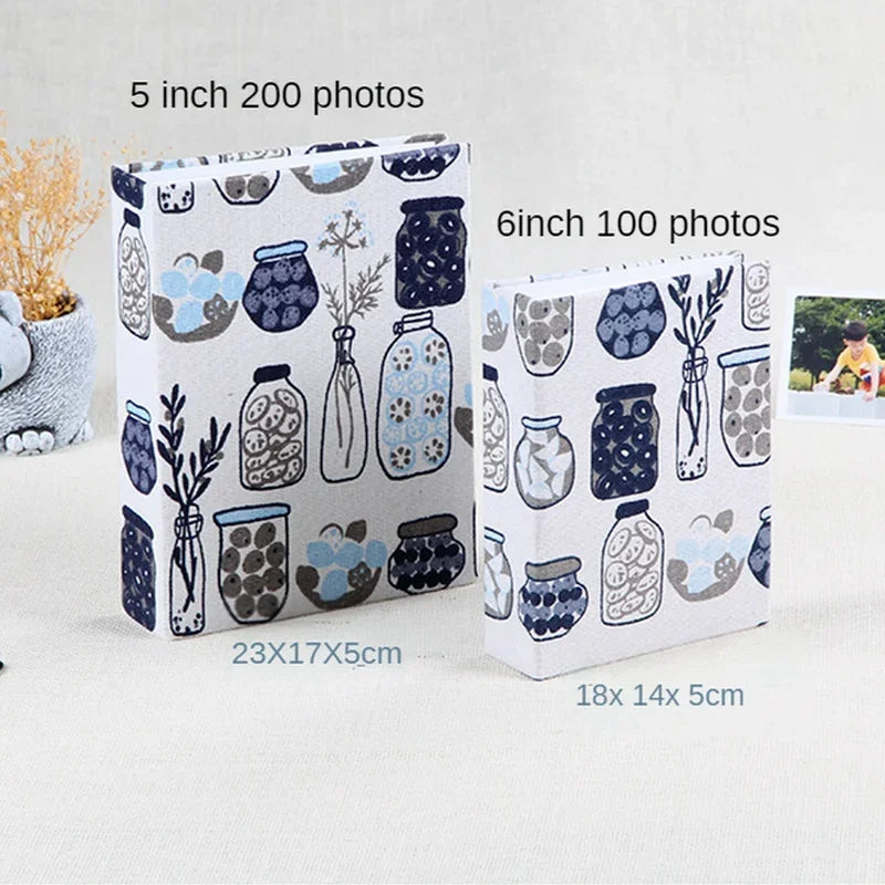 Two photo albums featuring blue and gray ceramic jars with floral designs, one 5 inch for 200 photos and one 6 inch for 100 p