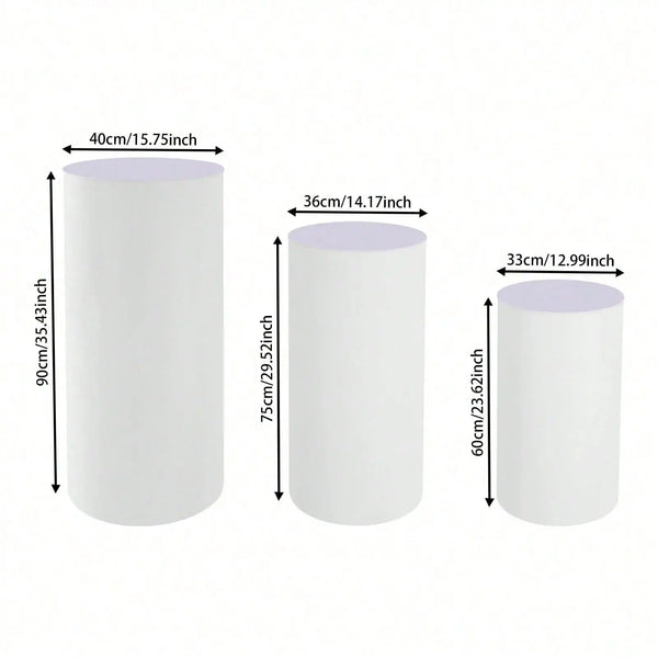 Set of three white cylinder pedestal display stands shown with various height measurements.