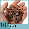 A hand holds a cluster of ten wooden crosses with epoxy hearts for spiritual comfort.