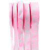Pink gingham ribbon rolls stacked vertically for gift wrapping and party decor