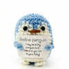 Handmade crochet penguin doll with a positivity card featuring the message I may be a tiny penguin but I believe in you go do