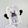 A white fluffy plush toy shaped like a bear holding a framed photo card.