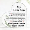 A clear heart-shaped acrylic keepsake plaque with engraved text saying My Dear Son and I love you now & forever, mom.