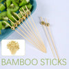 Gold accent bamboo sticks with spherical balls used as cocktail skewers for fruit and appetizers