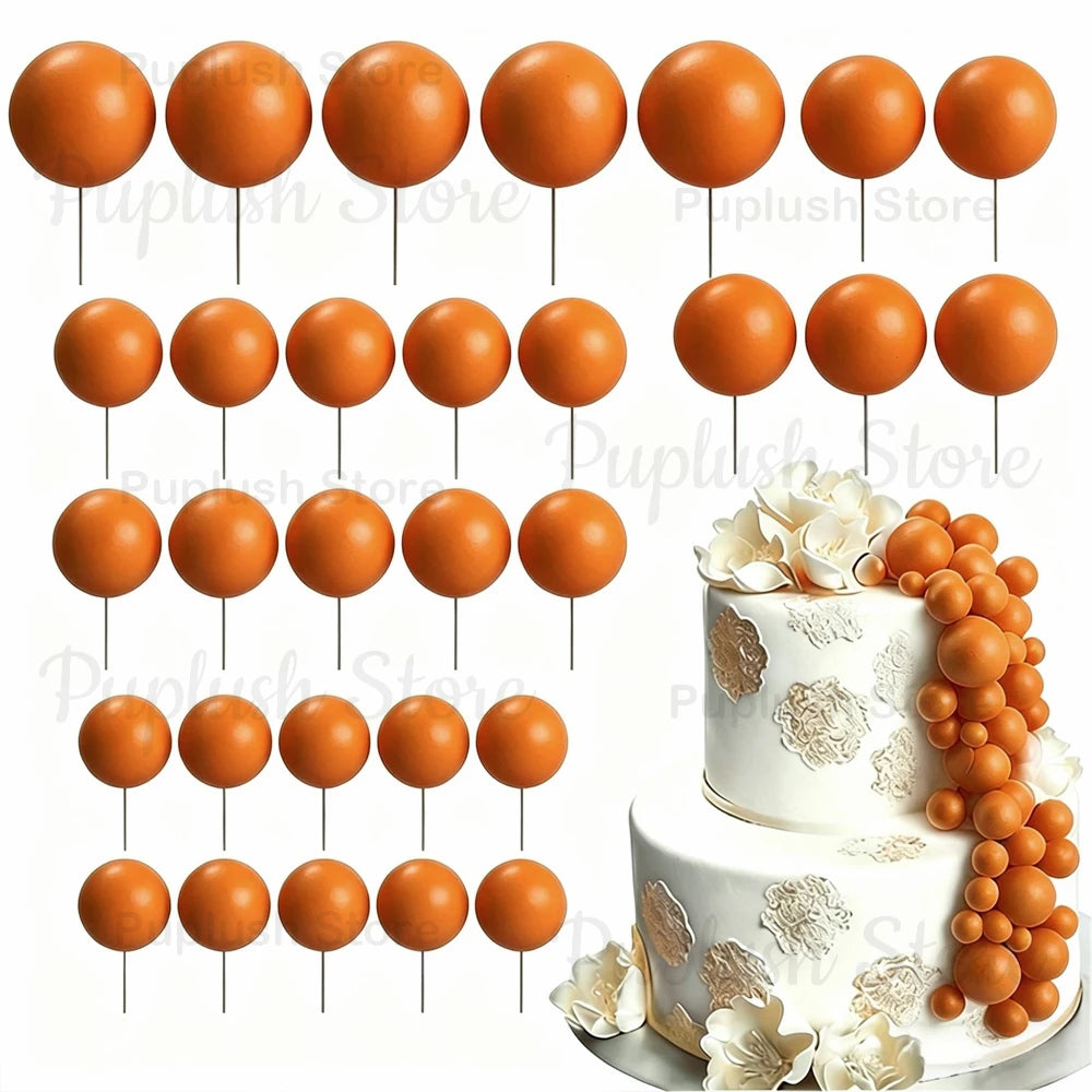 A set of round orange foam cake toppers displayed on white sticks.