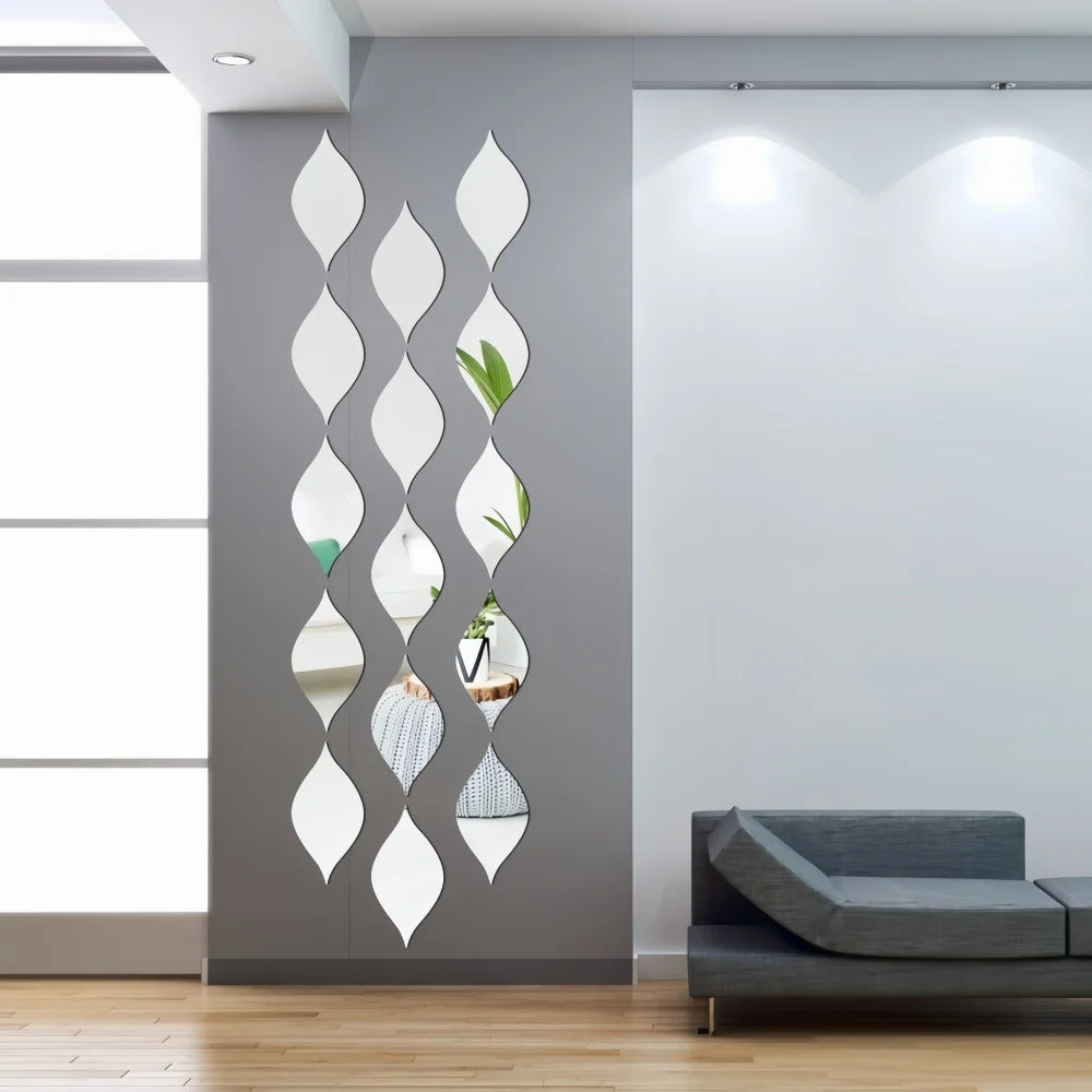 A vertical arrangement of ten reflective acrylic droplet mirrors mounted on a gray wall.