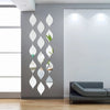 A vertical arrangement of ten reflective acrylic droplet mirrors mounted on a gray wall.