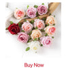 A bouquet of artificial roses and peonies in shades of pink, peach, and red arranged on a wooden surface.
