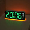 A digital alarm clock displaying 20:06 in bright green light on a white surface.