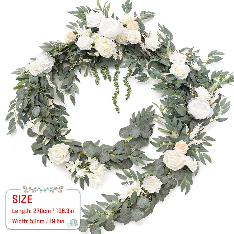 A wreath of green eucalyptus leaves and white and peach roses used for weddings and events